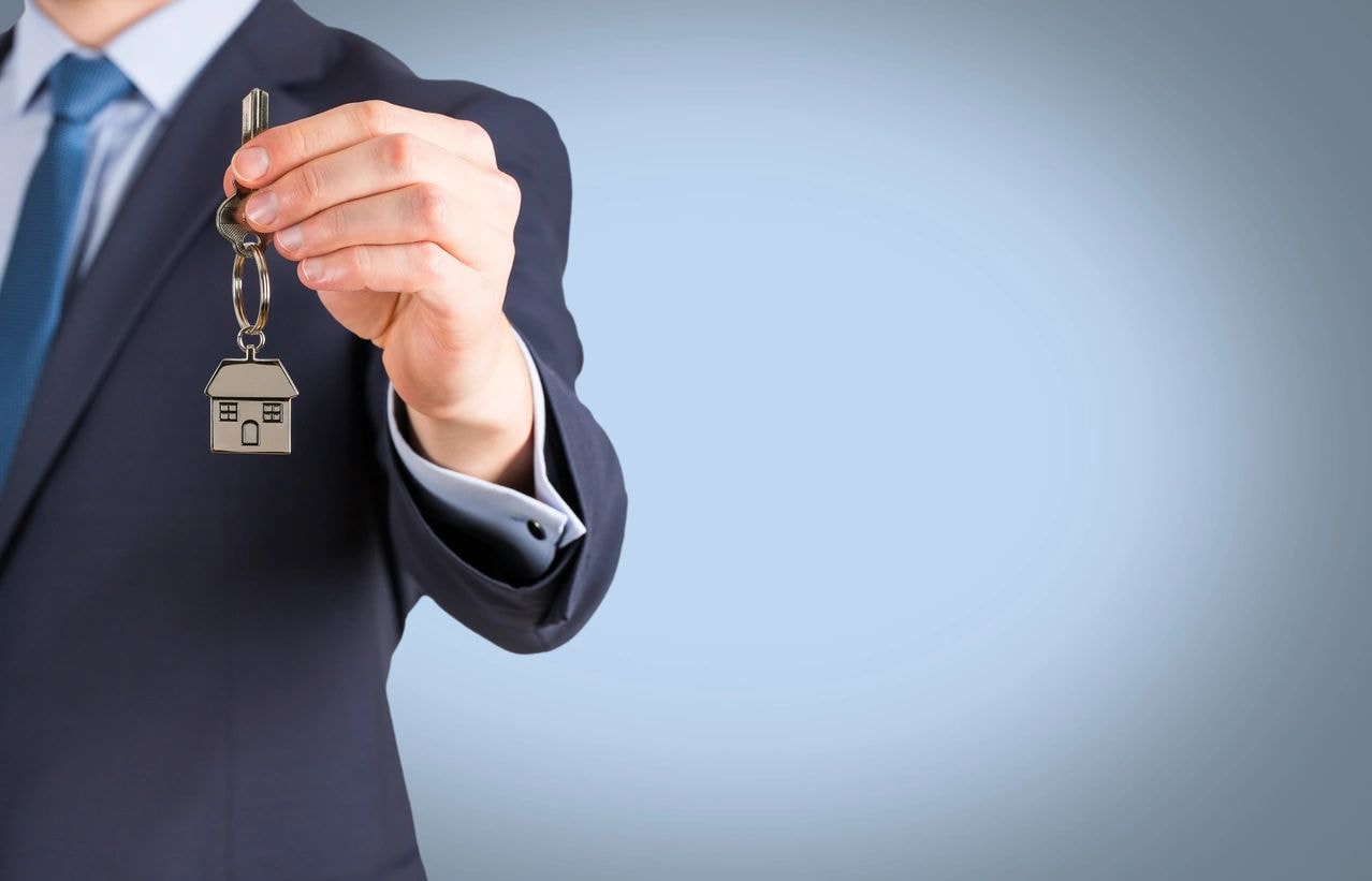 Businessman holding house key